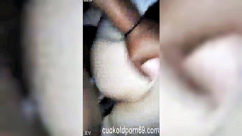 Blurry close-up of woman's hand with bracelet grabbing white sheets in amateur cuckold video