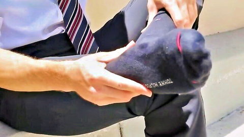 Luca in suit holding socked foot after work foot fetish thumbnail