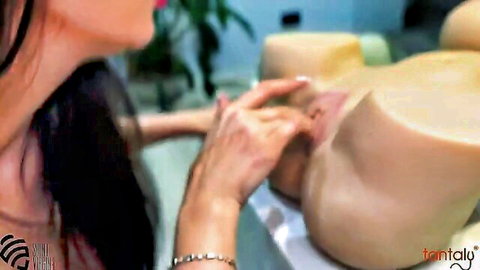 Woman with dark hair licking Tantaly sex doll pussy closeup