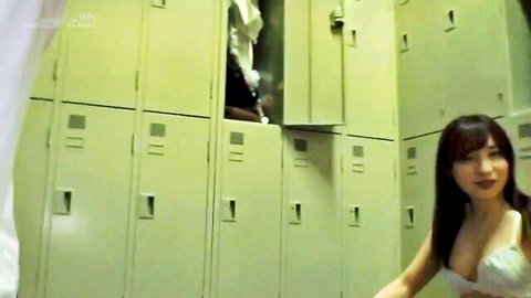 Busty Japanese babe in sexy white bra flashing big tits in locker room