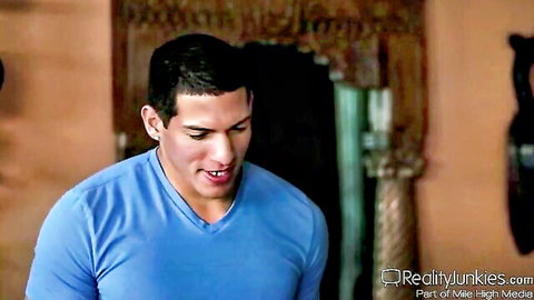 Handsome Latino man in blue v-neck shirt in exotic adult scene