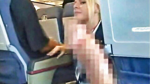 Blonde stewardess gives handjob to passenger in airplane seat