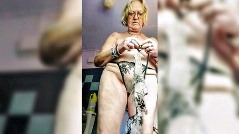 Mature blonde in lace lingerie knitting nude solo