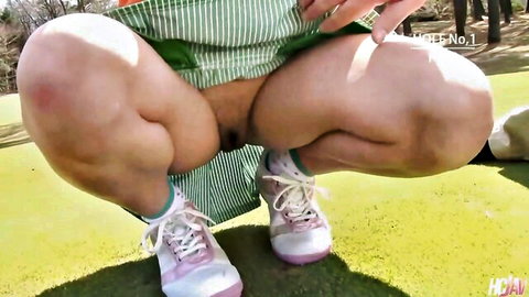 Asian babe squats on golf course lifting green skirt exposing hairy pussy outdoors