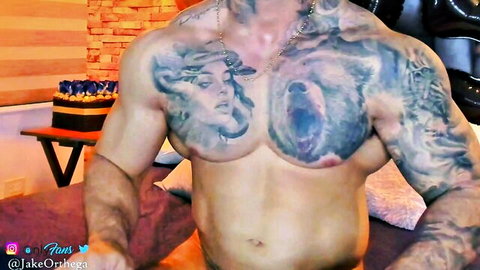 Muscular tattooed Jake Ortega shirtless pose in gay solo video