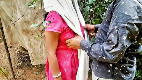 Indian man gropes wife's bare midriff outdoors in pink saree dupatta