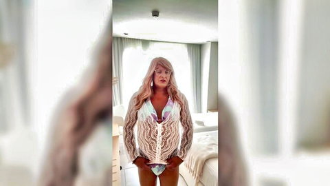 Blonde crossdresser Kelly in white lace bikini and heels posing seductively