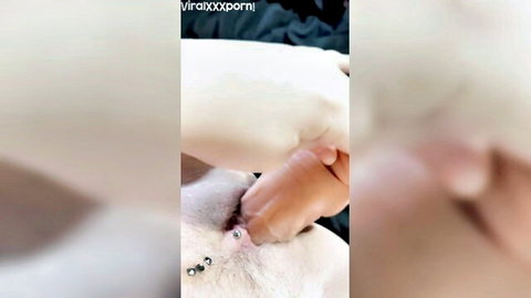 Woman stretching pierced pussy with huge dildo insertion