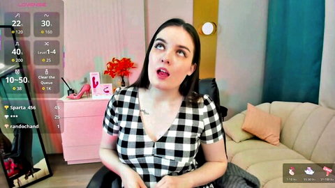 Shy Jenny Chaturbate camgirl in checkered top, teasing with big boobs and open mouth