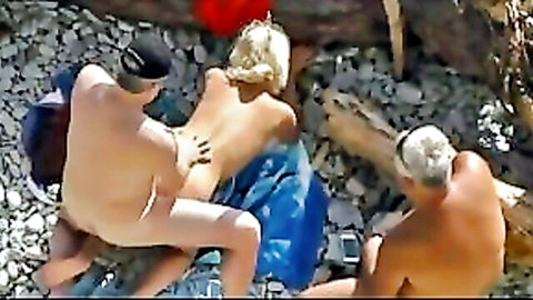 Mature blonde bent over getting pussy fucked doggy style by older naked man on rocky nudist beach