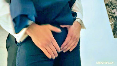 Hand groping suited man's crotch in gay encounter at Men at Play