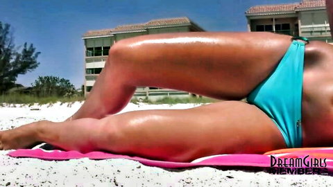 Lexi Lee in tight blue bikini on beach, oily curves teasing
