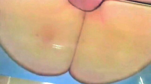 Close-up of big fat oily ass cheeks pressed against glass table