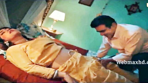 Indian woman in yellow saree intimate with man on bed, Ullu series scene