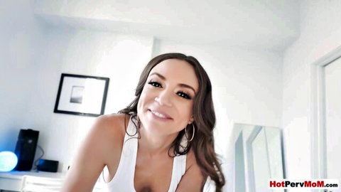 Curvy Latina MILF smiling seductively with deep big tits cleavage in tight white tank top