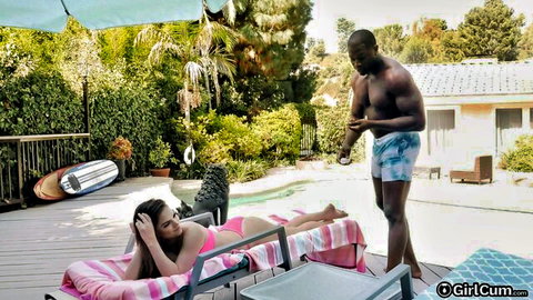 Athena Faris in pink bikini lounging by pool with muscular black man