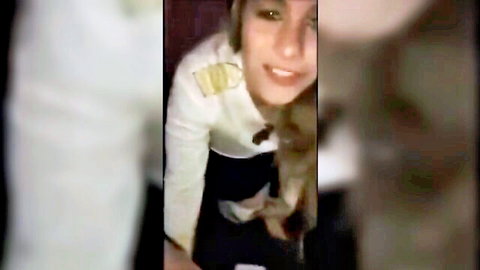 Blonde wife in sexy sailor uniform smiling playfully