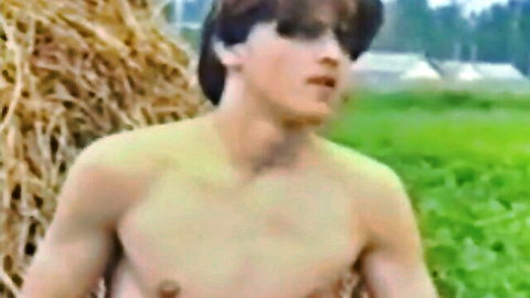 Shirtless twink in meadow, slim muscular build, outdoor handjob tease
