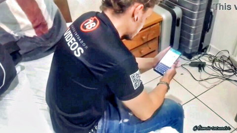 Sarah Rosa in casual black t-shirt and jeans, sitting with phone and luggage
