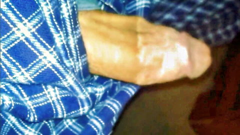Amateur young man pulls down blue plaid pajamas revealing huge erect cock
