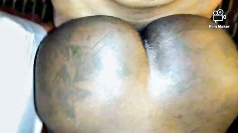 Ebony woman's large tattooed ass in close-up explicit view