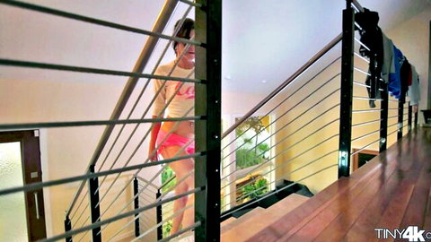 Curvy brunette in pink thong and white top climbing stairs teasingly