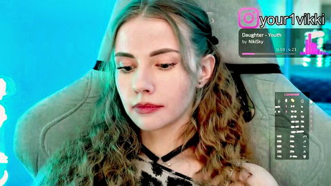 Sexy young webcam girl yourvikki pouts seductively in black choker and gaming chair