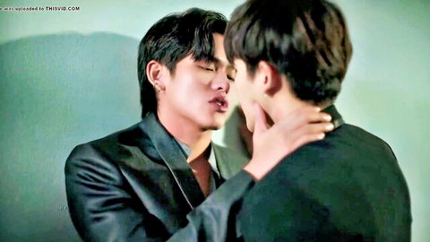 Two Asian men in suits sharing intense neck kiss in boys love scene