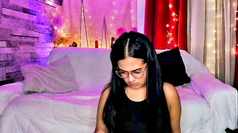 Naughtyrouse in black tank top and glasses, long black hair, seductive cam pose