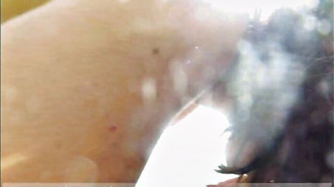 Blurry closeup of sweaty hairy armpit skin glistening with sweat drops