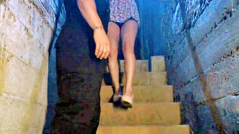 Skinny brunette climbs stairs with floral dress lifted exposing bare pussy and small ass as man gropes her thighs from behind