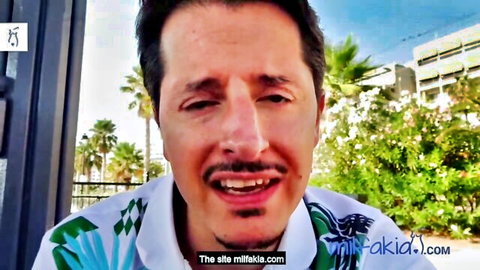 Smiling mustached man in colorful shirt outdoors with palm trees at milfakia beach