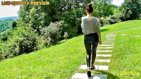 Ellie in shiny grey leggings walking outdoors, teasing piss fetish vibe