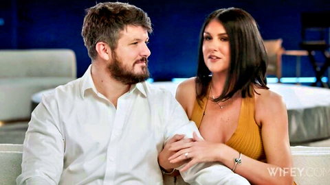 Brunette MILF with huge tits in yellow dress cuddles bearded husband on couch