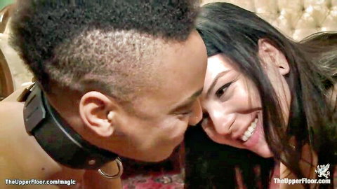 Nikki Darling and Juliette March kissing intimately in BDSM collar scene