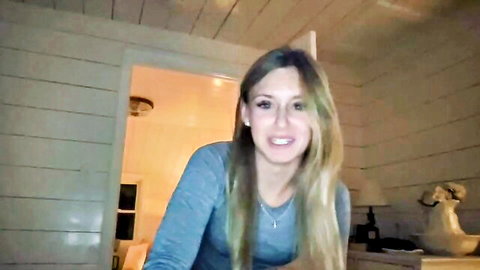 Carlybora smiling innocently as cute blonde in gray sweater on Chaturbate