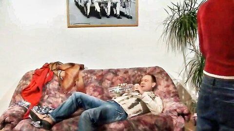 Amateur German wife giving blowjob to husband on sofa