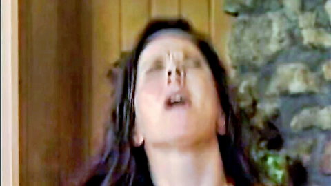 Brunette woman with thick cum dripping from nose and open mouth in intense facial closeup
