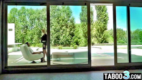 Skinny blonde babe in tiny black shorts teasing by glass door overlooking outdoor pool