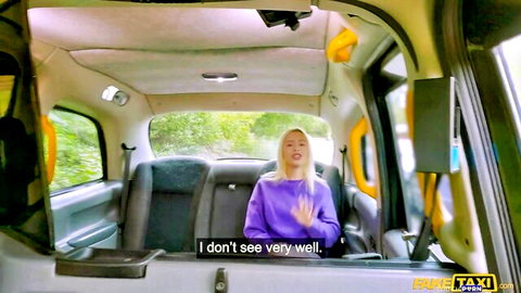 Blonde babe in purple sweater gesturing 'I don't see very well' in Fake Taxi cab