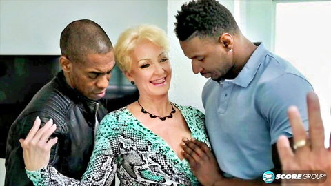 Mature blonde with big tits squeezed between two muscular black guys in teasing threesome