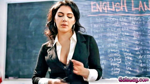 Seductive brunette teacher unbuttons blouse revealing massive cleavage in classroom