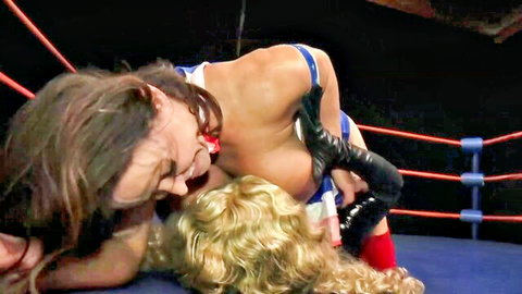 Brunette wrestler pins busty blonde in intense catfight hold on ring mat