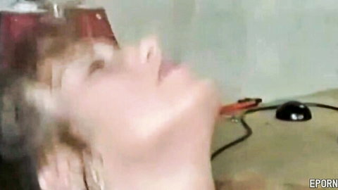 Blonde retro MILF giving blowjob in garage scene