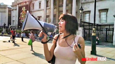 Milo Moire topless shouting into megaphone in public square