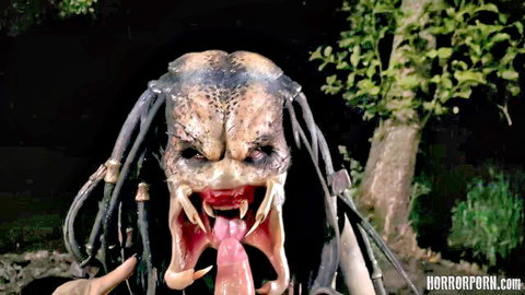Predator cosplay in dark forest, snarling mouth with long tongue out, pointing finger