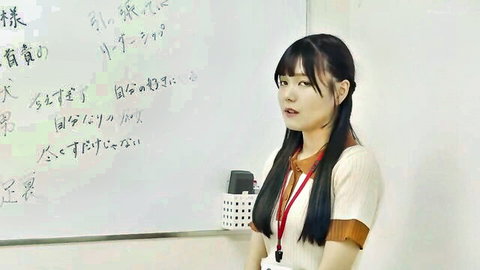 Japanese teacher in classroom uniform by whiteboard, seductive smile