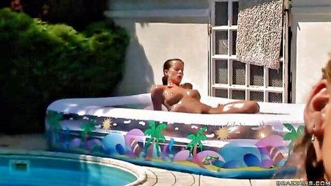 Wet brunette with big tits enjoys deep penetration in inflatable pool by the side