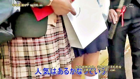 Japanese women in plaid school skirts and white socks holding wooden sword, group scene