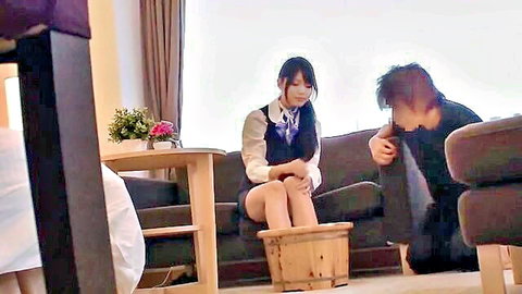 Japanese schoolgirl in uniform receives foot massage from man